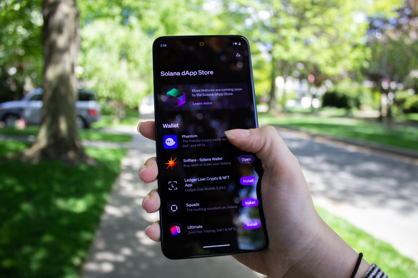 Person using Solana wallet app on smartphone in a modern city setting, illustrating blockchain adoption in urban finance